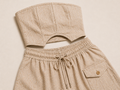 Beige strapless top and shorts set on a beige background